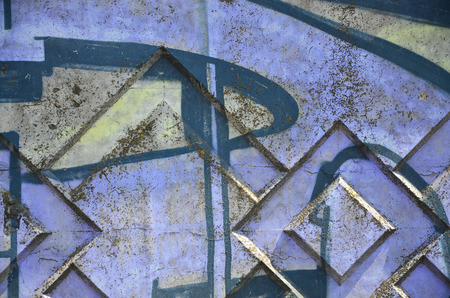 Texture of a fragment of the wall with graffiti painting, which is depicted on it. An image of a piece of graffiti drawing as a photo on street art and graffiti culture topicsの写真素材
