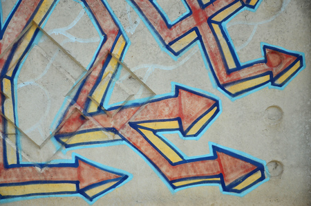 Texture of a fragment of the wall with graffiti painting, which is depicted on it. An image of a piece of graffiti drawing as a photo on street art and graffiti culture topicsの写真素材
