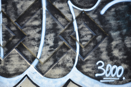 Texture of a fragment of the wall with graffiti painting, which is depicted on it. An image of a piece of graffiti drawing as a photo on street art and graffiti culture topicsの写真素材