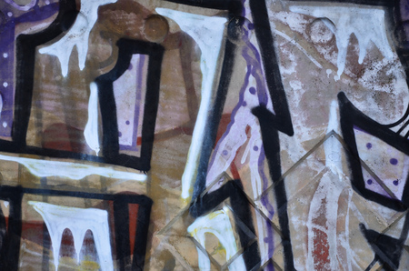 Texture of a fragment of the wall with graffiti painting, which is depicted on it. An image of a piece of graffiti drawing as a photo on street art and graffiti culture topicsの写真素材