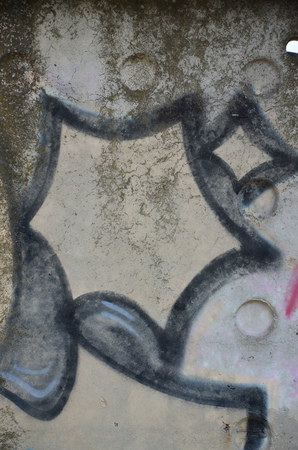 Texture of a fragment of the wall with graffiti painting, which is depicted on it. An image of a piece of graffiti drawing as a photo on street art and graffiti culture topicsの写真素材