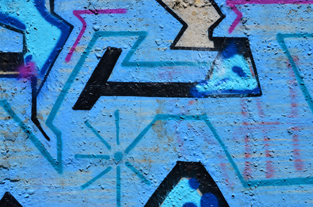 Texture of a fragment of the wall with graffiti painting, which is depicted on it. An image of a piece of graffiti drawing as a photo on street art and graffiti culture topicsの写真素材