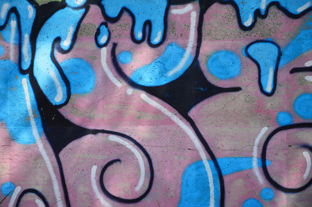 Texture of a fragment of the wall with graffiti painting, which is depicted on it. An image of a piece of graffiti drawing as a photo on street art and graffiti culture topicsの写真素材