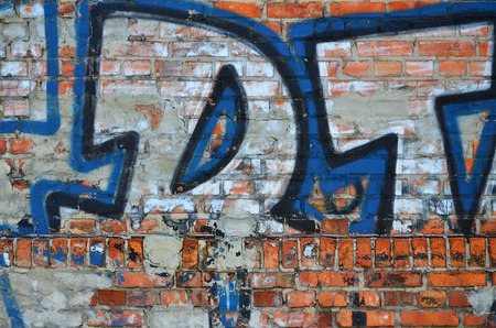 Texture of a fragment of the wall with graffiti painting, which is depicted on it. An image of a piece of graffiti drawing as a photo on street art and graffiti culture topicsの写真素材