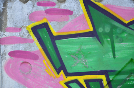 Texture of a fragment of the wall with graffiti painting, which is depicted on it. An image of a piece of graffiti drawing as a photo on street art and graffiti culture topicsの写真素材