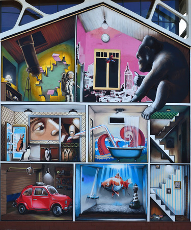 Detailed image of color graffiti drawing with fish, penguins, monkey, cosmonaut, octopus, bathyscaphe, marine lighthouse, toaster, red car in the garage, staircase and rat hole with donutsの写真素材