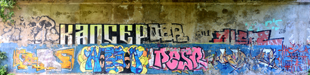Detailed image of very old and aged color graffiti drawing on the wall. Background grunge street art pictureの写真素材
