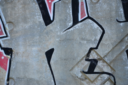 Texture of a fragment of the wall with graffiti painting, which is depicted on it. An image of a piece of graffiti drawing as a photo on street art and graffiti culture topicsの写真素材