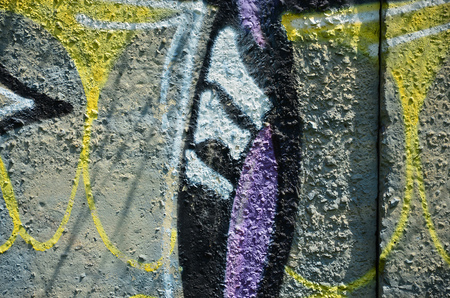 Texture of a fragment of the wall with graffiti painting, which is depicted on it. An image of a piece of graffiti drawing as a photo on street art and graffiti culture topicsの写真素材