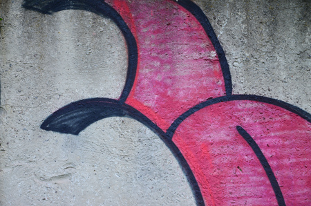 Texture of a fragment of the wall with graffiti painting, which is depicted on it. An image of a piece of graffiti drawing as a photo on street art and graffiti culture topicsの写真素材