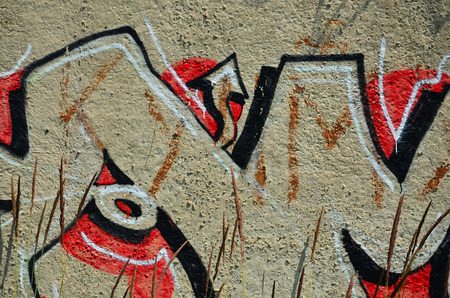 Texture of a fragment of the wall with graffiti painting, which is depicted on it. An image of a piece of graffiti drawing as a photo on street art and graffiti culture topicsの写真素材