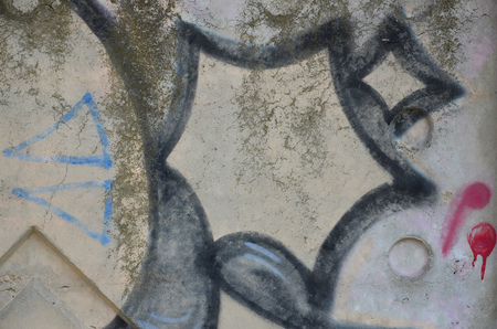 Texture of a fragment of the wall with graffiti painting, which is depicted on it. An image of a piece of graffiti drawing as a photo on street art and graffiti culture topicsの写真素材