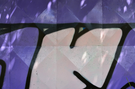 Texture of a fragment of the wall with graffiti painting, which is depicted on it. An image of a piece of graffiti drawing as a photo on street art and graffiti culture topicsの写真素材
