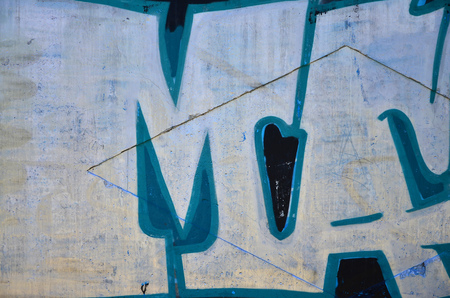 Texture of a fragment of the wall with graffiti painting, which is depicted on it. An image of a piece of graffiti drawing as a photo on street art and graffiti culture topicsの写真素材