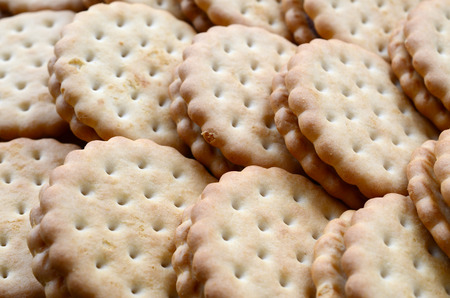 Detailed picture of round sandwich cookies with coconut filling. Background image of a close-up of...