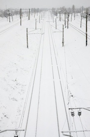 Winter railway landscape, Railway tracks in the snow-covered industrial countryの写真素材