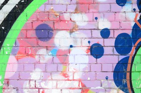 Close-up fragment of a graffiti drawing applied to the wall by aerosol paint. Background image of a modern composition of lines and colored areas. Street art conceptの写真素材