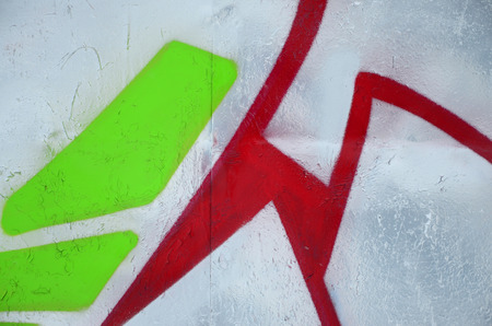 Close-up fragment of a graffiti drawing applied to the wall by aerosol paint. Background image of a modern composition of lines and colored areas. Street art conceptの写真素材