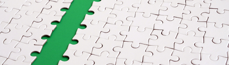 The green path is laid on the platform of a white folded jigsaw puzzle. Texture image with copy space for textの写真素材