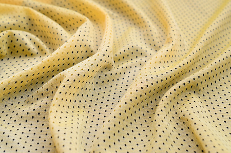 Yellow sport jersey clothing fabric texture and background with many folds
