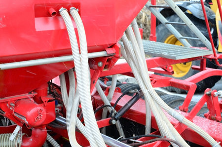 Springs and tubes are arranged in a row. A row of seeder. Heavy equipment on agricultural exhibition