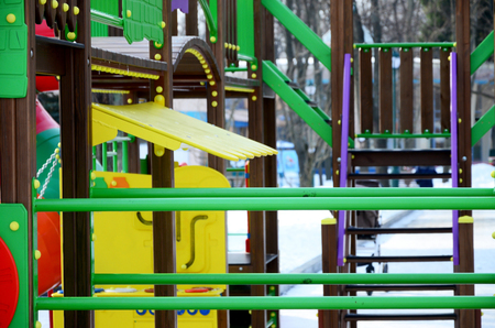 Fragment of a playground made of plastic and wood, painted in different colorsの写真素材