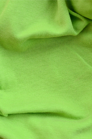The texture of the fabric is bright green. Material for making shirts and blousesの写真素材