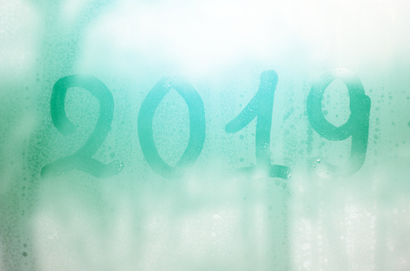 2019. The figures are written on the misted glass in winterの写真素材