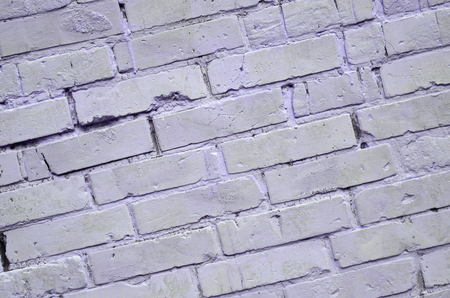 Background texture of old brick wall, painted in violetの写真素材
