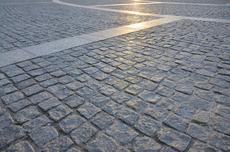 Fragment of the street square, folded out of a gray square paving stoneの写真素材