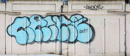 The old wall, painted in color graffiti drawing blue aerosol paints. Background image on the theme...