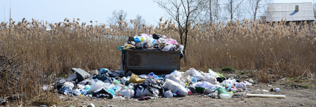 The garbage can is packed with garbage and waste. Untimely removal of garbage in populated areas