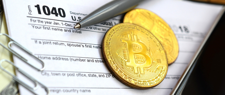 The pen, bitcoins and dollar bills is lies on the tax form 1040 U.S. Individual Income Tax Return. The time to pay taxesの写真素材