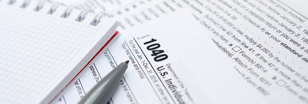 The pen and notebook is lies on the tax form 1040 U.S. Individual Income Tax Return. The time to pay...