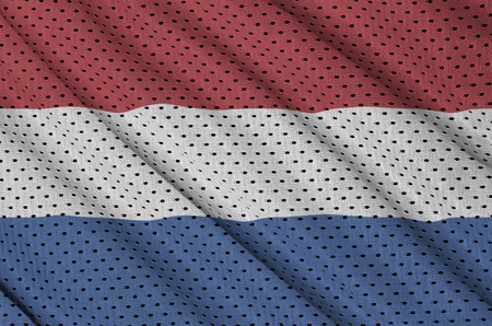 Netherlands flag printed on a polyester nylon sportswear mesh fabric with some foldsの写真素材