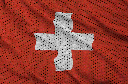 Switzerland flag printed on a polyester nylon sportswear mesh fabric with some foldsの写真素材