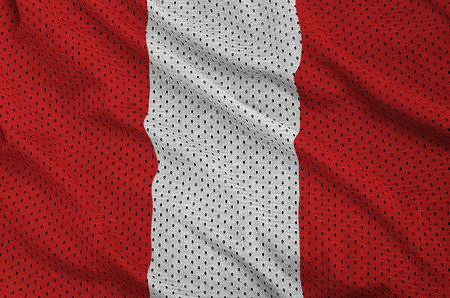 Peru flag printed on a polyester nylon sportswear mesh fabric with some foldsの写真素材