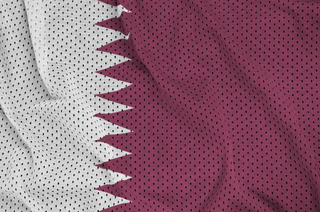 Qatar flag printed on a polyester nylon sportswear mesh fabric with some foldsの写真素材