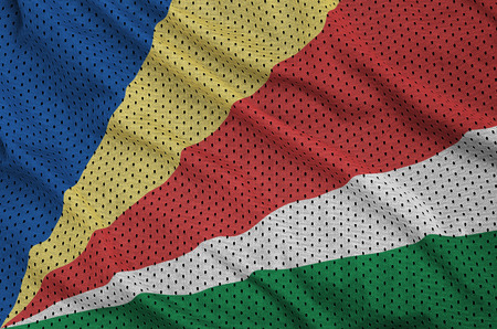 Seychelles flag printed on a polyester nylon sportswear mesh fabric with some foldsの写真素材