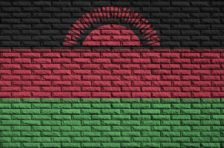 Malawi flag is painted onto an old brick wallの写真素材