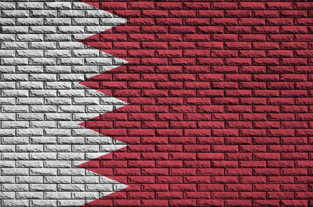 Bahrain flag is painted onto an old brick wallの写真素材