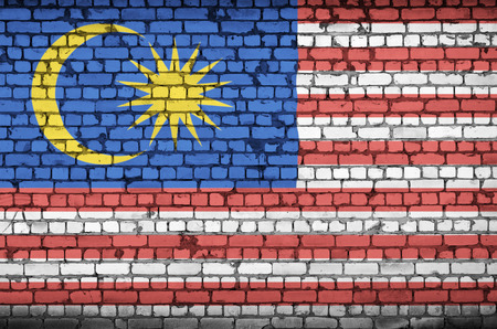 Malaysia flag is painted onto an old brick wallの写真素材