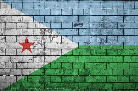 Djibouti flag is painted onto an old brick wallの写真素材