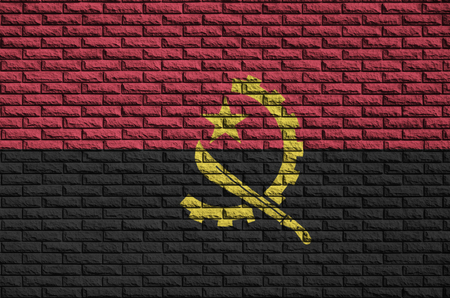 Angola flag is painted onto an old brick wallの写真素材
