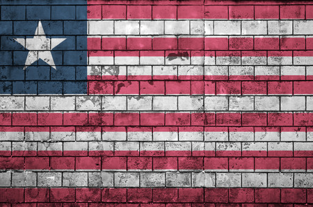 Liberia flag is painted onto an old brick wallの写真素材