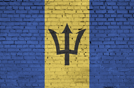 Barbados flag is painted onto an old brick wallの写真素材