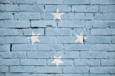 Micronesia flag is painted onto an old brick wallの写真素材