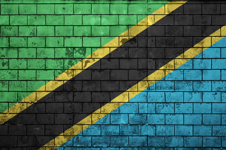 Tanzania flag is painted onto an old brick wallの写真素材