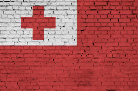 Tonga flag is painted onto an old brick wallの写真素材