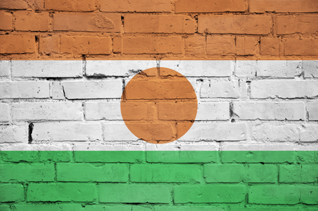 Niger flag is painted onto an old brick wallの写真素材